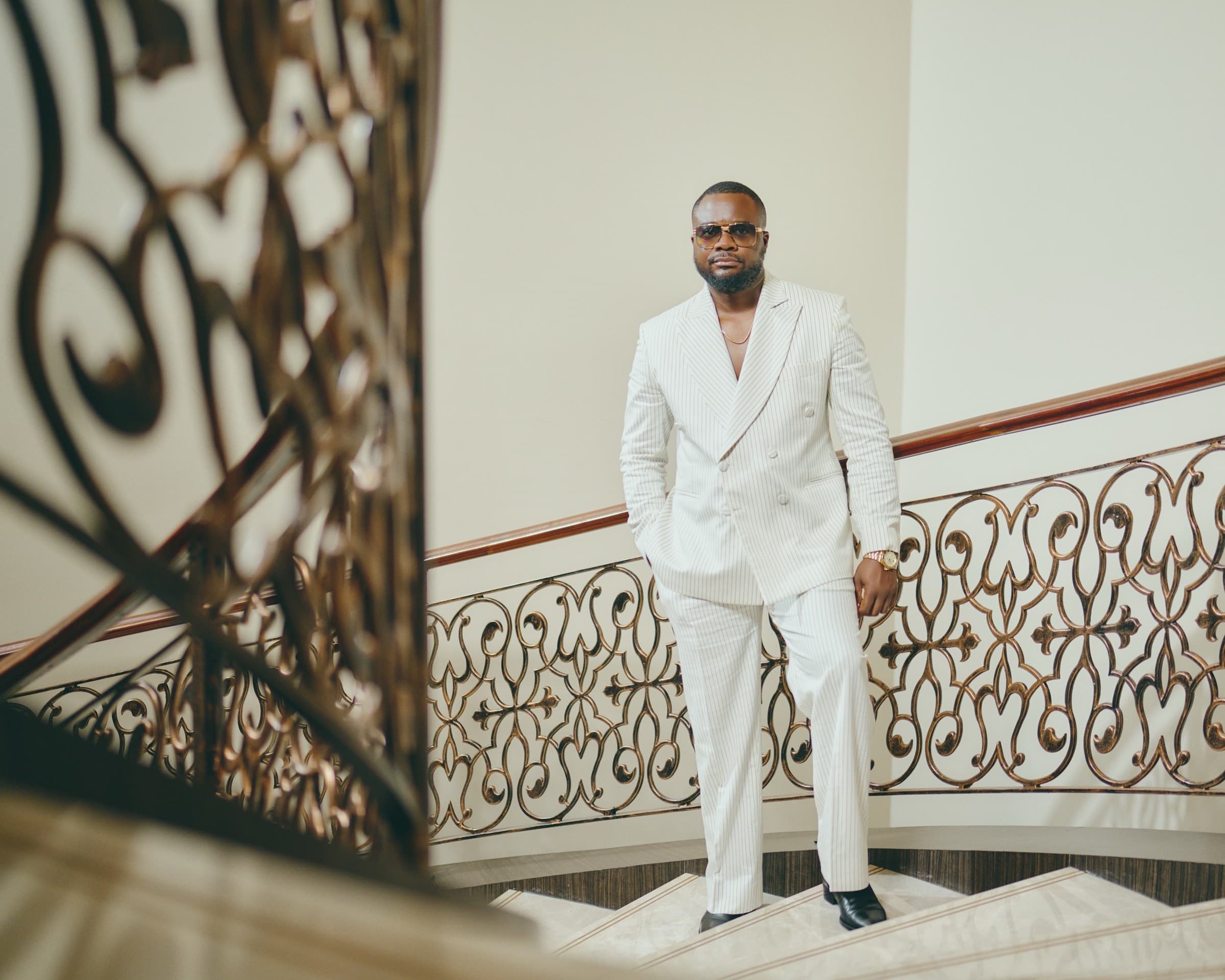 Dubai personal brand photography. Executive portrait on ornate staircase.