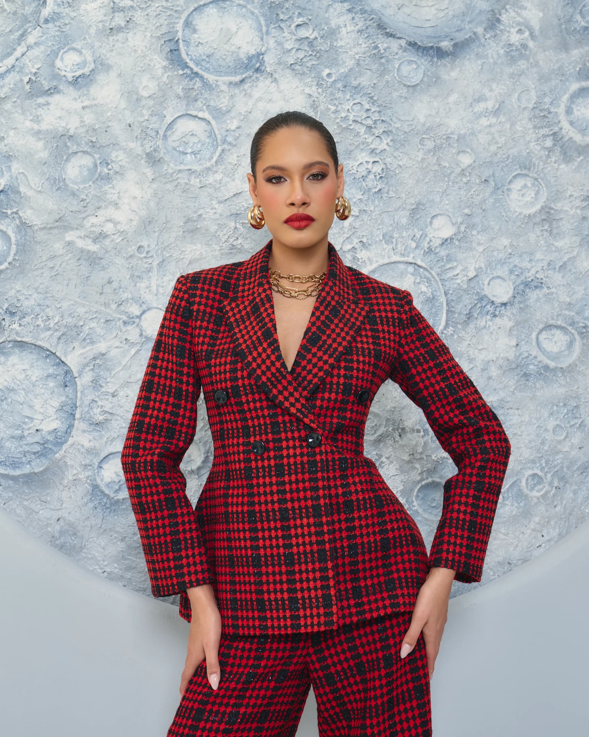 Editorial photography by Deine, red checked suit against a circular textured backdrop