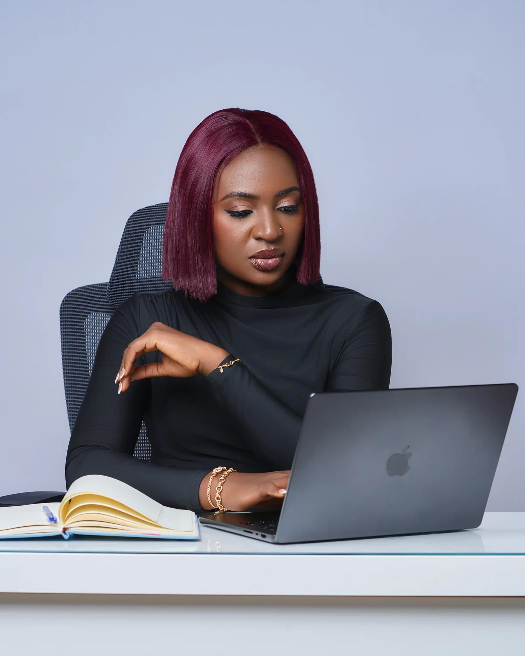 Personal brand photography in Dubai at a desk with a laptop and notebook